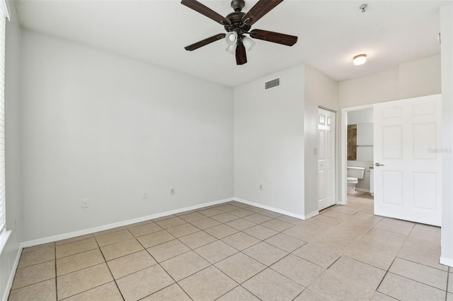 5606 Pinnacle Heights Cir Unit 304, Tampa, FL 33624 - empty room with light tile patterned flooring, ceiling fan, baseboards, and fire sprinkler in ceiling