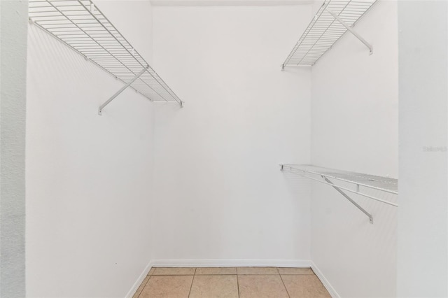 5606 Pinnacle Heights Cir Unit 304, Tampa, FL 33624 - walk in closet with light tile patterned flooring