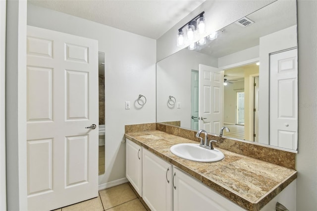 5606 Pinnacle Heights Cir Unit 304, Tampa, FL 33624 - bathroom with tile patterned floors, vanity, baseboards, and ceiling fan