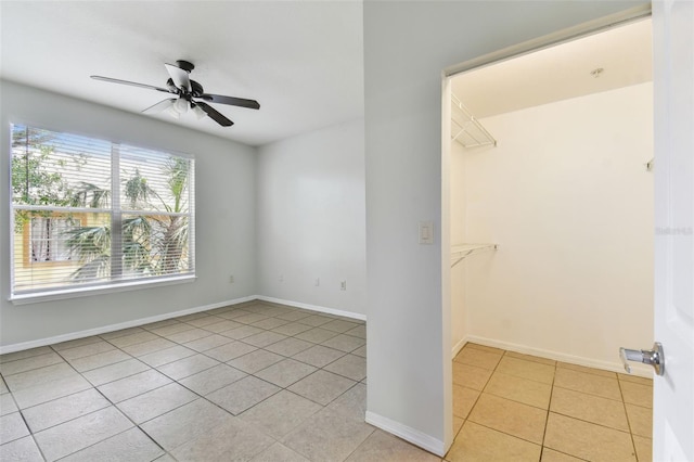 5606 Pinnacle Heights Cir Unit 304, Tampa, FL 33624 - unfurnished bedroom featuring light tile patterned flooring, baseboards, and a ceiling fan