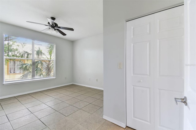 5606 Pinnacle Heights Cir Unit 304, Tampa, FL 33624 - spare room featuring light tile patterned flooring, baseboards, and a ceiling fan