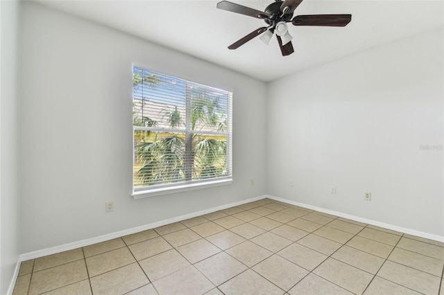 5606 Pinnacle Heights Cir Unit 304, Tampa, FL 33624 - spare room with baseboards, light tile patterned floors, and ceiling fan