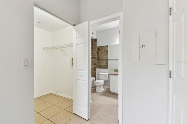 5606 Pinnacle Heights Cir Unit 304, Tampa, FL 33624 - full bathroom with toilet, tile patterned floors, electric panel, a tile shower, and vanity