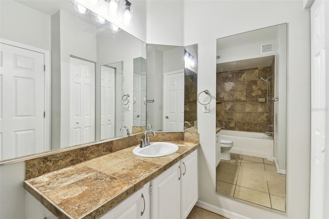 5606 Pinnacle Heights Cir Unit 304, Tampa, FL 33624 - full bath featuring toilet, vanity, tile patterned floors, shower / bathtub combination, and baseboards
