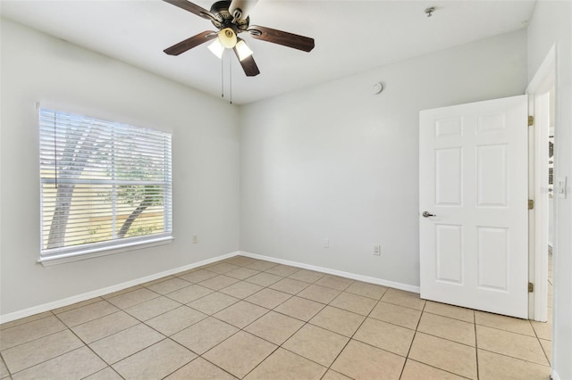 5606 Pinnacle Heights Cir Unit 304, Tampa, FL 33624 - empty room featuring light tile patterned floors, a ceiling fan, a pendent fire sprinkler, and baseboards