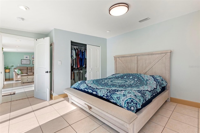 bedroom featuring tile patterned floors and a closet