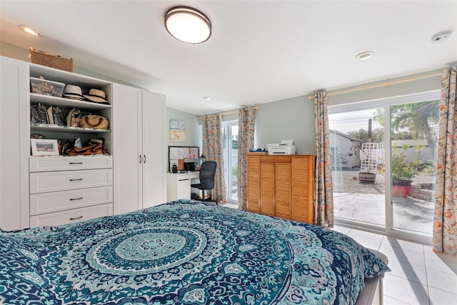 bedroom with access to outside and light tile patterned flooring