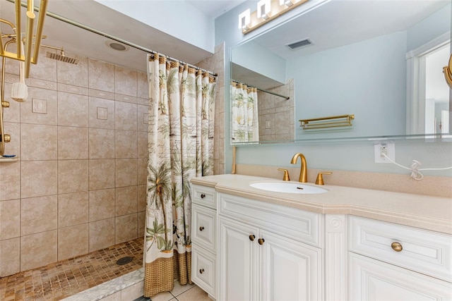 bathroom featuring a shower with shower curtain, tile patterned flooring, and vanity