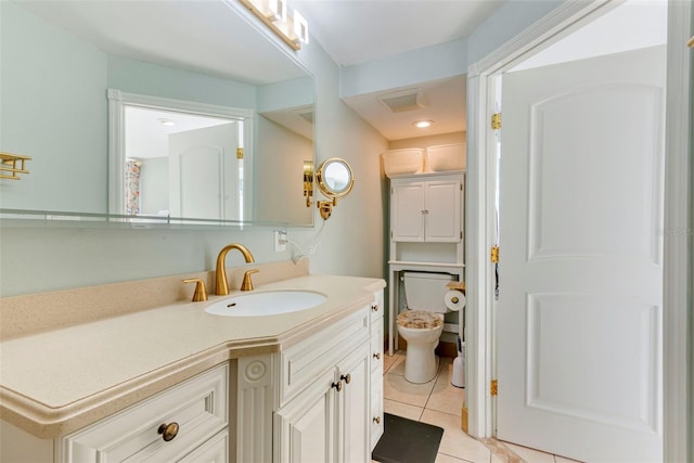 bathroom with vanity, tile patterned flooring, and toilet