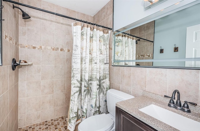 bathroom with toilet, walk in shower, vanity, tile walls, and backsplash