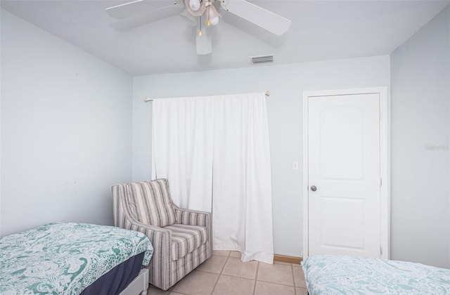 tiled bedroom with ceiling fan