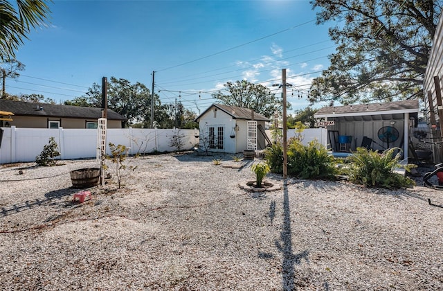 view of yard with french doors and an outbuilding