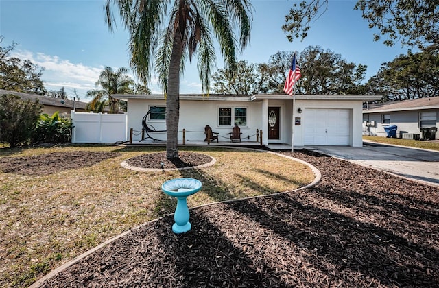 single story home featuring a front lawn and a garage