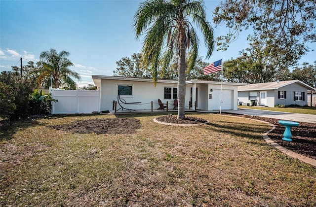 ranch-style house featuring a front yard and a garage