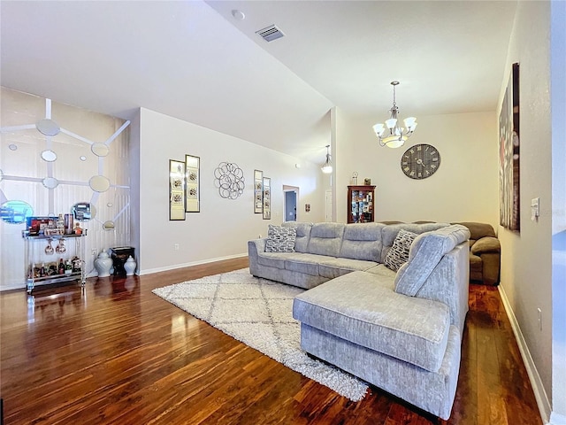 living room with lofted ceiling, an inviting chandelier, and dark wood-type flooring