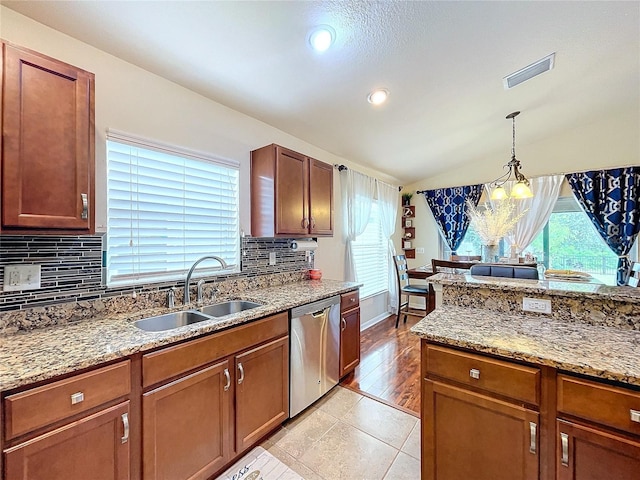 kitchen with dishwasher, sink, an inviting chandelier, decorative light fixtures, and lofted ceiling