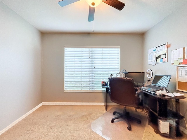 carpeted office featuring ceiling fan