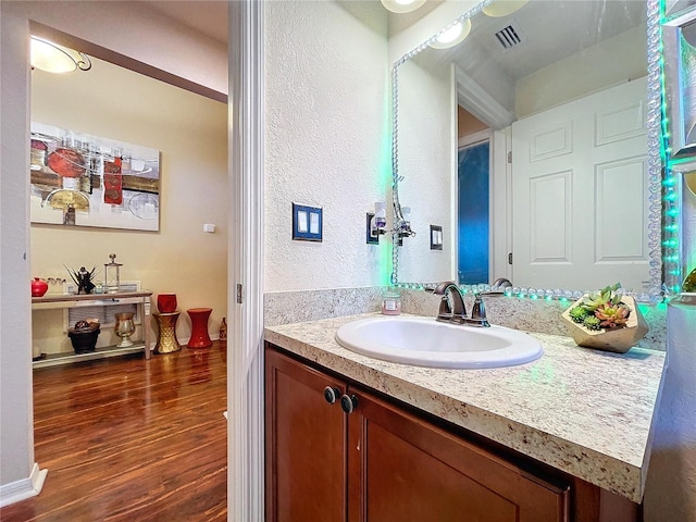 bathroom with hardwood / wood-style floors and vanity