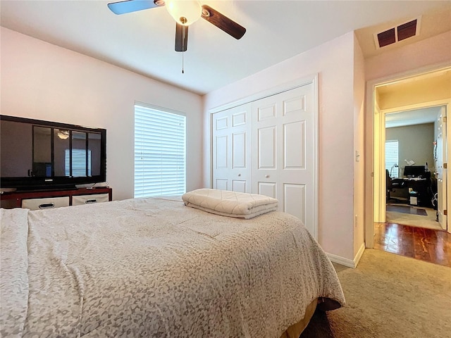 bedroom featuring ceiling fan, a closet, and carpet floors