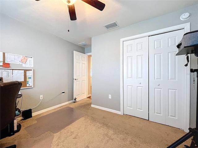 carpeted office featuring ceiling fan