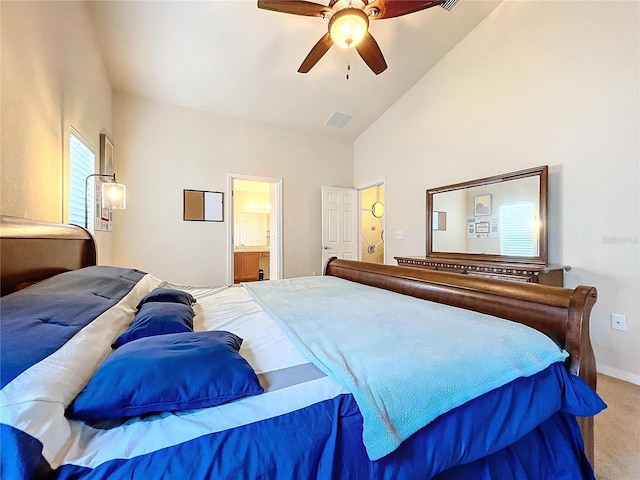 carpeted bedroom with high vaulted ceiling, ensuite bath, and ceiling fan