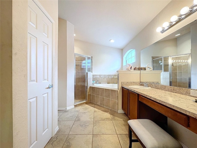 bathroom with tile patterned floors, vanity, and shower with separate bathtub