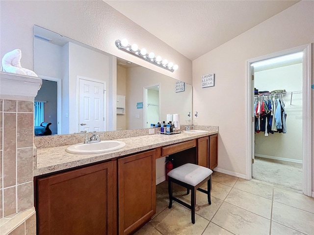 bathroom featuring vanity, tile patterned floors, and lofted ceiling