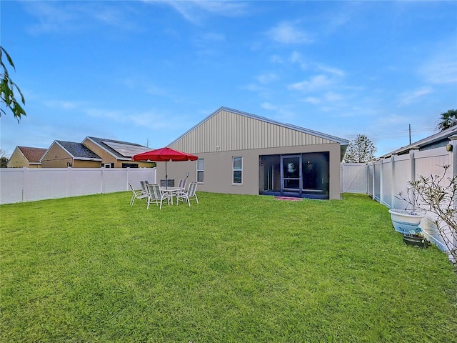 rear view of house with a lawn