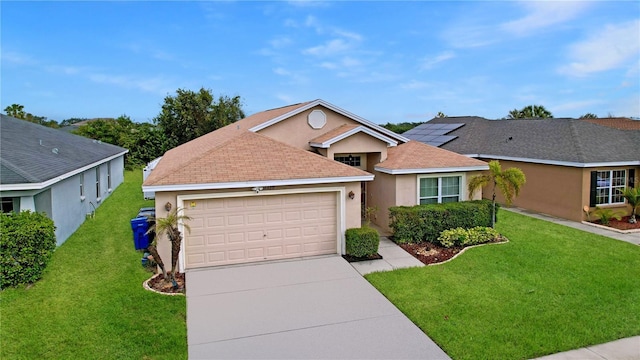 view of front facade with a front yard, solar panels, and a garage