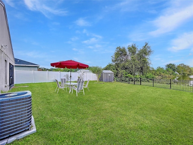 view of yard with a storage shed and central air condition unit