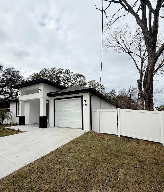 view of property exterior with a garage and a yard