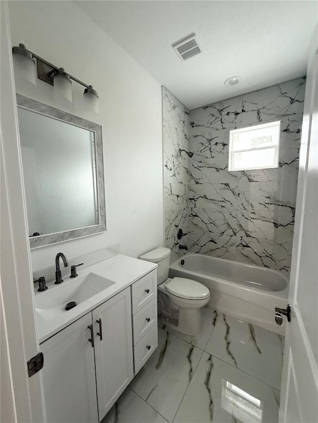 full bathroom with tiled shower / bath combo, toilet, and vanity