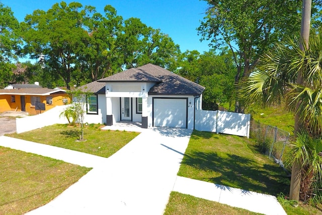 408 E Hanlon St, Tampa, FL 33604 - view of front of house with concrete driveway, stucco siding, fence, a front lawn, and a garage