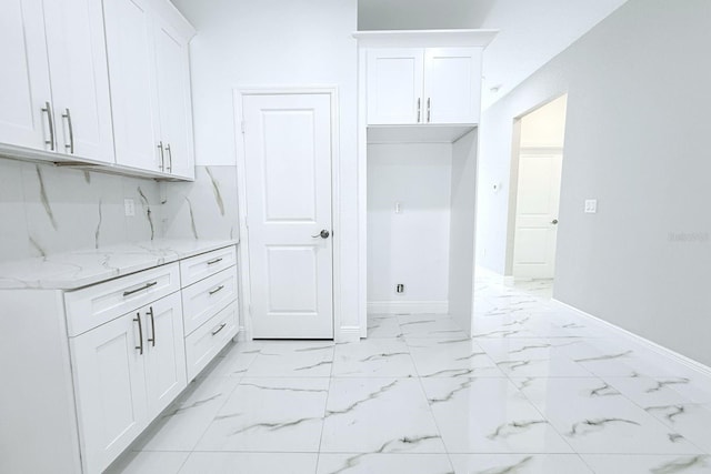408 E Hanlon St, Tampa, FL 33604 - kitchen featuring decorative backsplash, white cabinets, baseboards, marble finish floor, and light stone countertops