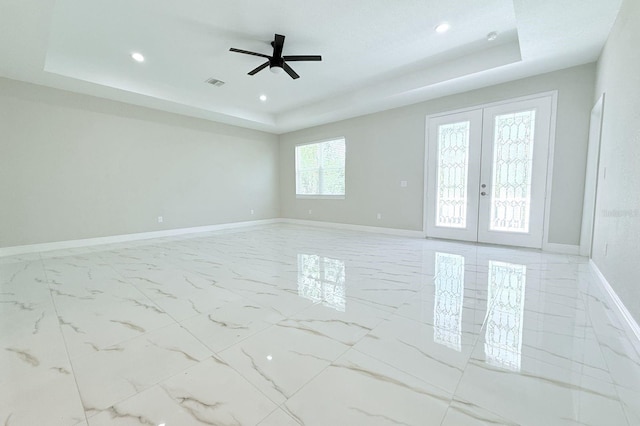 408 E Hanlon St, Tampa, FL 33604 - spare room with a tray ceiling, baseboards, and visible vents