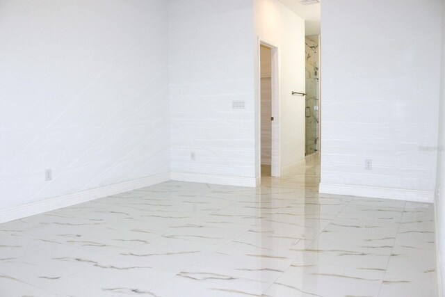 408 E Hanlon St, Tampa, FL 33604 - empty room with marble finish floor and baseboards