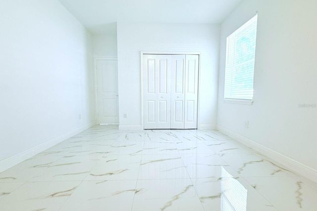 408 E Hanlon St, Tampa, FL 33604 - unfurnished bedroom featuring marble finish floor, baseboards, and a closet