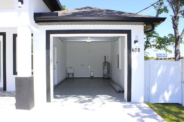 408 E Hanlon St, Tampa, FL 33604 - garage featuring water heater, fence, and a sink