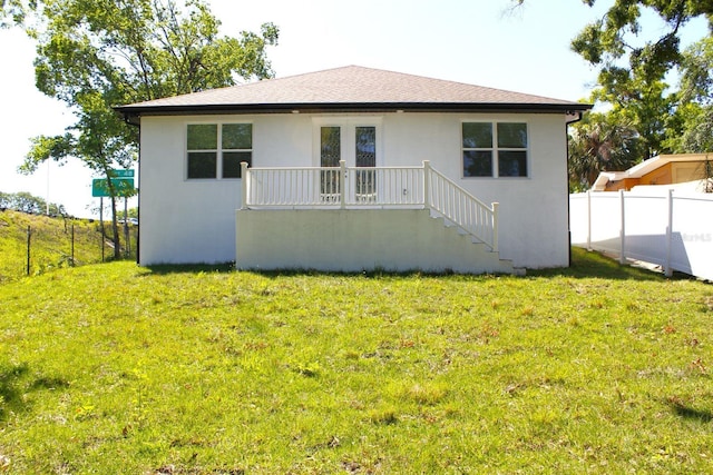 408 E Hanlon St, Tampa, FL 33604 - rear view of property featuring stucco siding, fence, french doors, and a yard