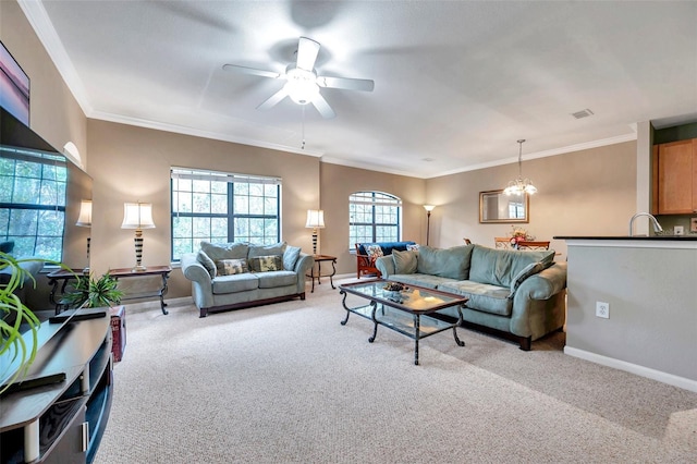 living room featuring crown molding, sink, light colored carpet, and ceiling fan with notable chandelier