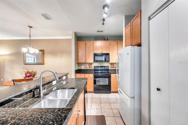 kitchen with track lighting, black appliances, sink, decorative light fixtures, and a chandelier