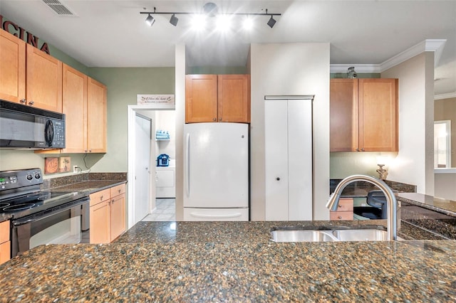 kitchen featuring dark stone counters, sink, black appliances, and track lighting