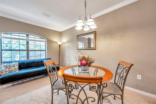 dining room with carpet flooring, an inviting chandelier, and crown molding