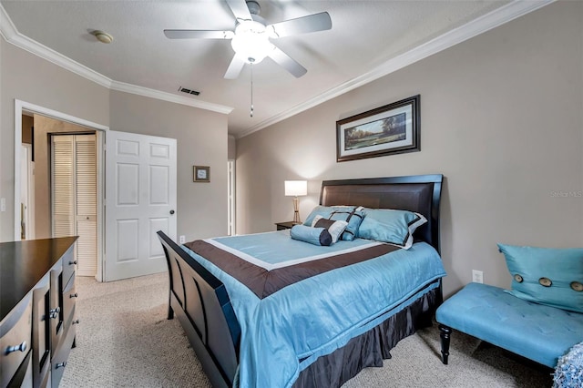 bedroom featuring ceiling fan, a closet, light carpet, and ornamental molding