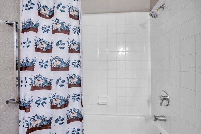 bathroom with shower / bath combo with shower curtain