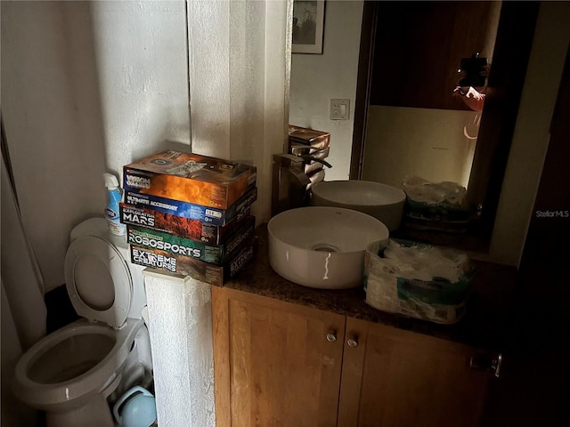 bathroom featuring toilet and vanity