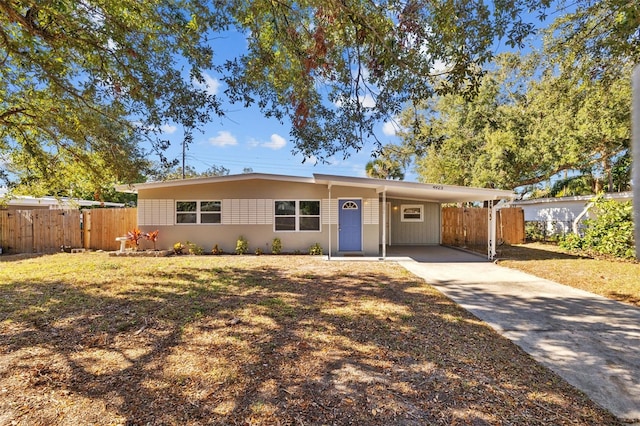 ranch-style house with a front lawn and a carport