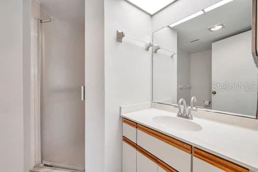 bathroom featuring vanity and a shower