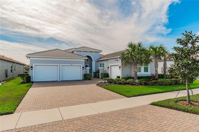 view of front of house with a front yard and a garage