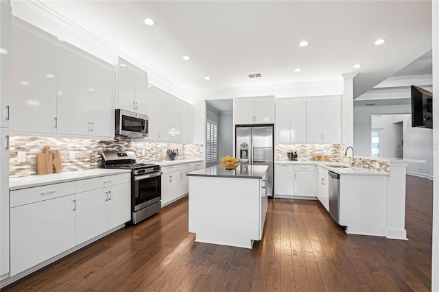 kitchen with white cabinets, appliances with stainless steel finishes, and sink